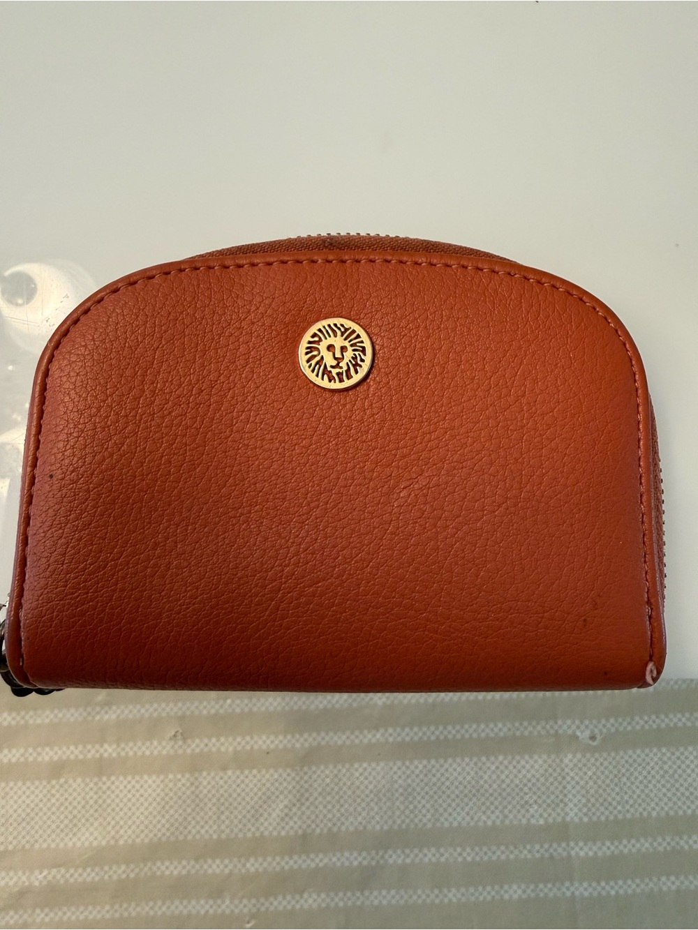 Anne Klein Rust Zip-Around Card Wallet with Gold Lion Emblem
